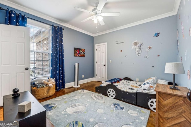 bedroom featuring crown molding, dark wood-type flooring, and ceiling fan