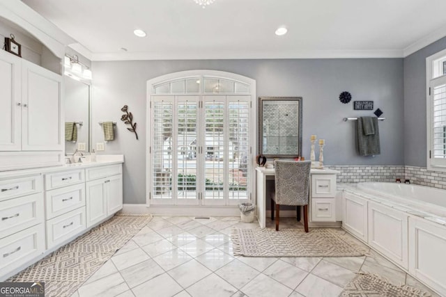 bathroom featuring vanity, a bathtub, ornamental molding, and plenty of natural light