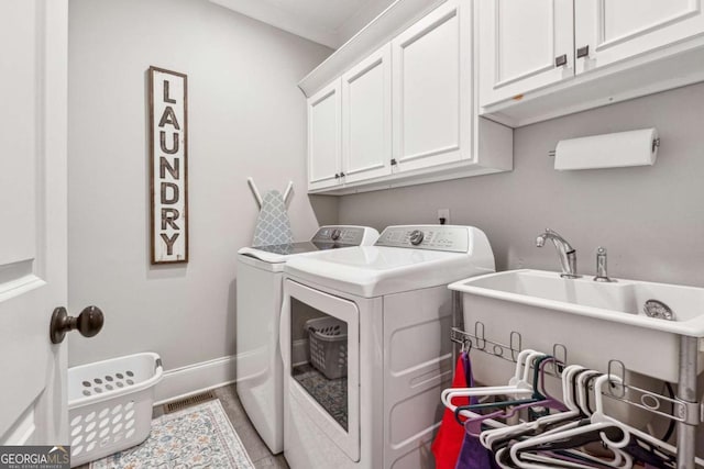 laundry room featuring sink, cabinets, washer and clothes dryer, and ornamental molding