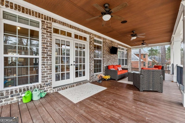 wooden terrace featuring ceiling fan, french doors, and an outdoor hangout area