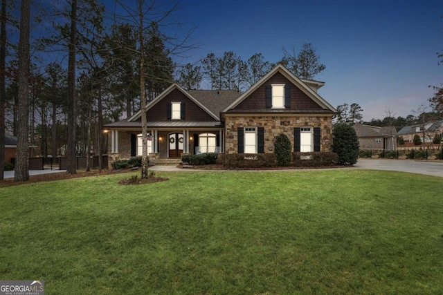 craftsman-style home featuring a yard and a porch