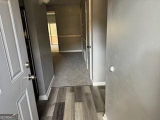 hallway with dark hardwood / wood-style flooring