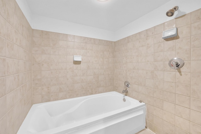 bathroom featuring tile walls and a bath