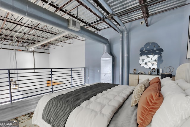 bedroom with hardwood / wood-style flooring