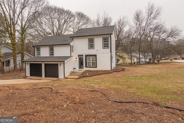 front of property featuring a garage and a front lawn