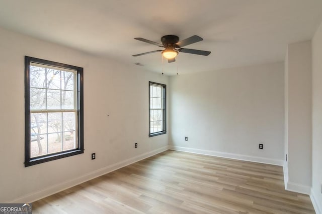 spare room with ceiling fan and light hardwood / wood-style floors