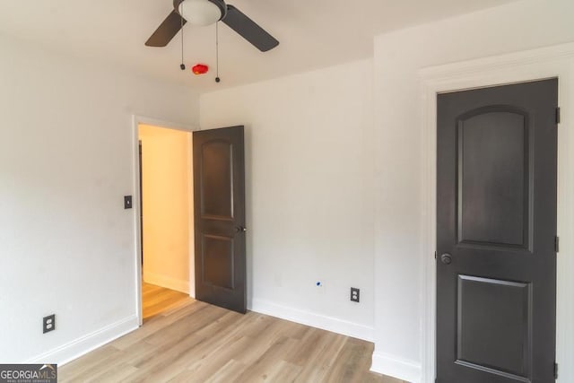 unfurnished room with ceiling fan and light wood-type flooring