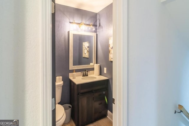 bathroom featuring toilet and vanity