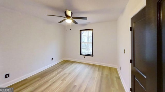 spare room featuring light hardwood / wood-style flooring and ceiling fan