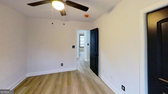 empty room featuring light wood-type flooring and ceiling fan