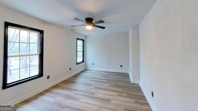 unfurnished room featuring light wood-type flooring and ceiling fan