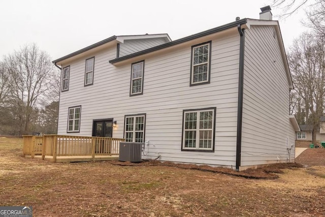 back of property featuring central AC unit and a wooden deck