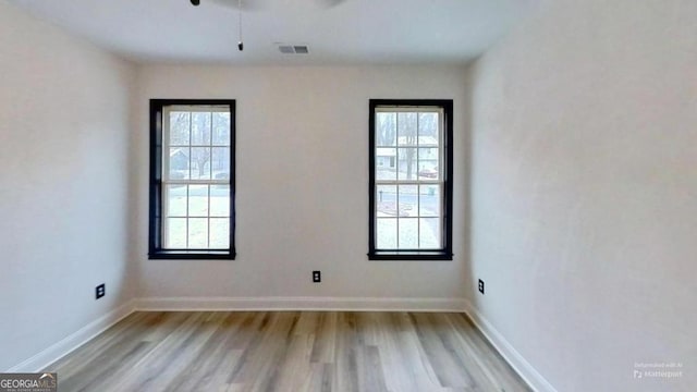 unfurnished room with a healthy amount of sunlight and light wood-type flooring