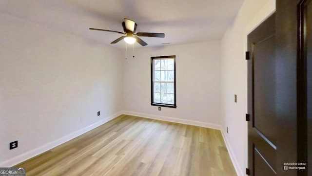 empty room featuring light hardwood / wood-style flooring and ceiling fan