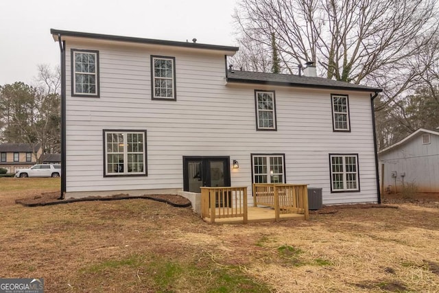 back of house with a yard and central air condition unit