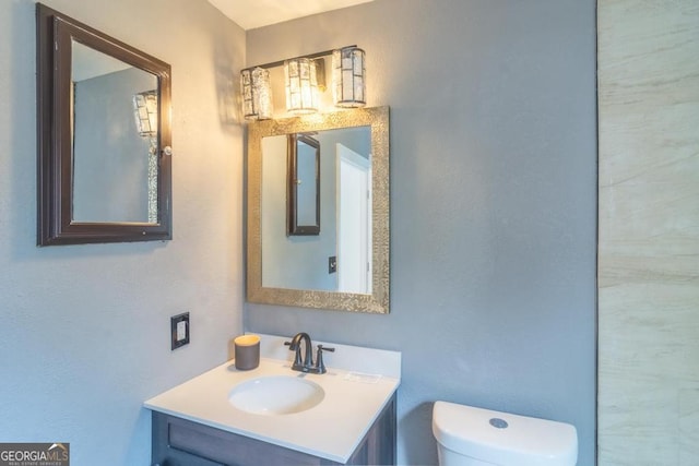 bathroom featuring toilet and vanity