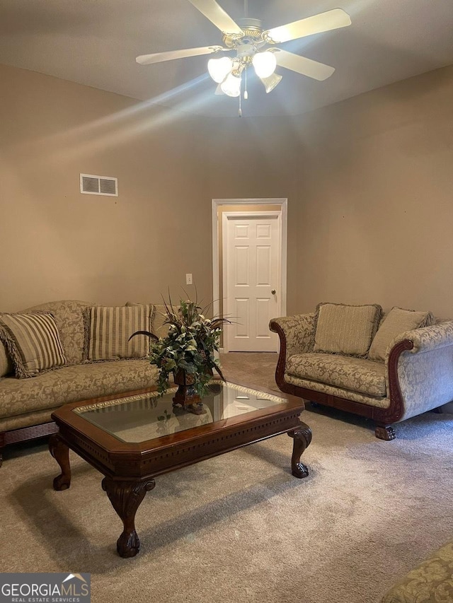 living area with carpet floors, ceiling fan, and visible vents