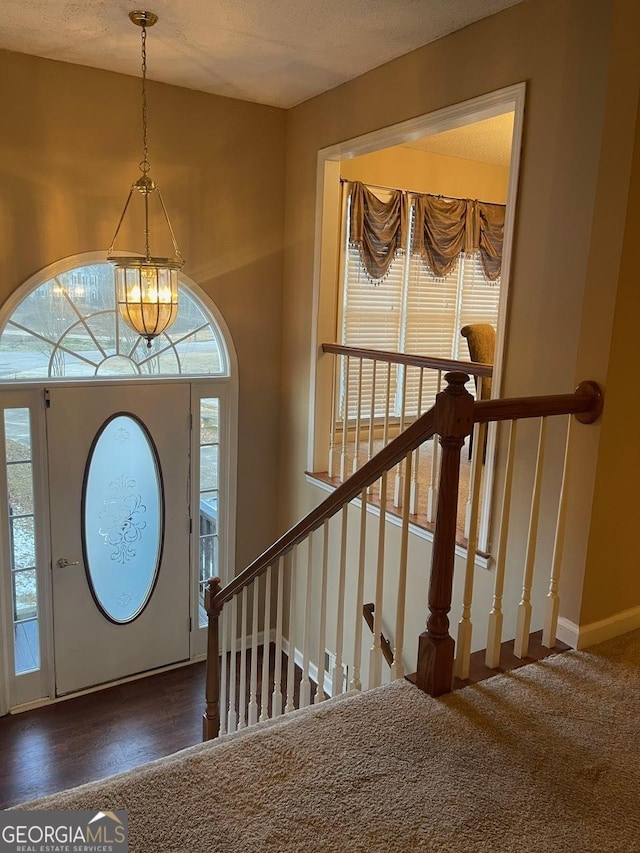 entryway with wood finished floors and baseboards