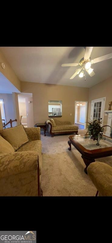 living room featuring carpet flooring and a ceiling fan