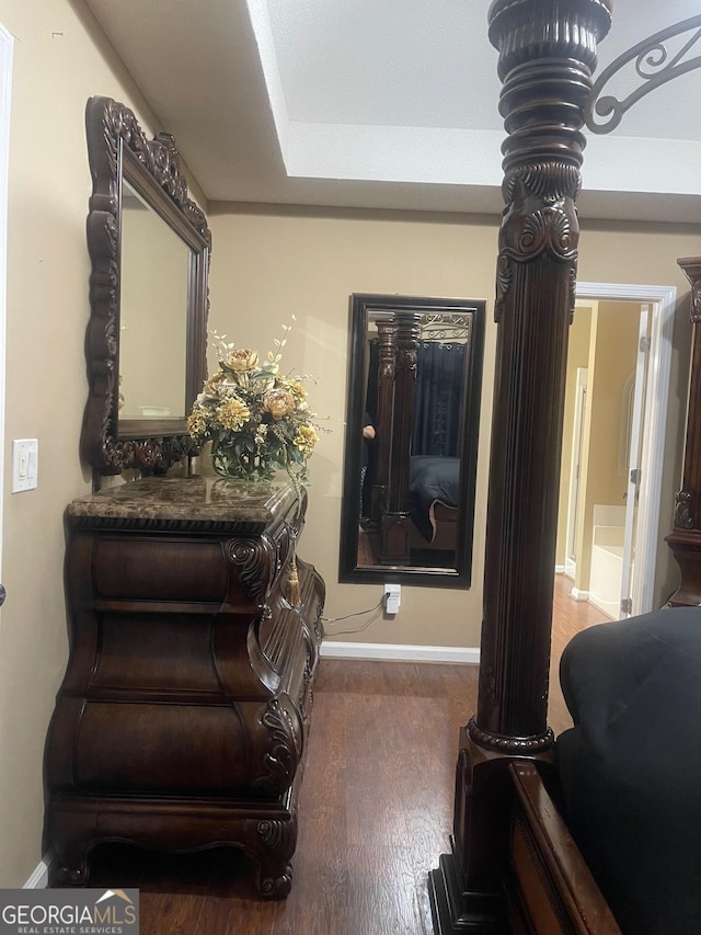 interior space with wood finished floors and baseboards