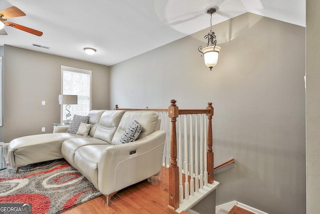 living room with light wood-type flooring and ceiling fan