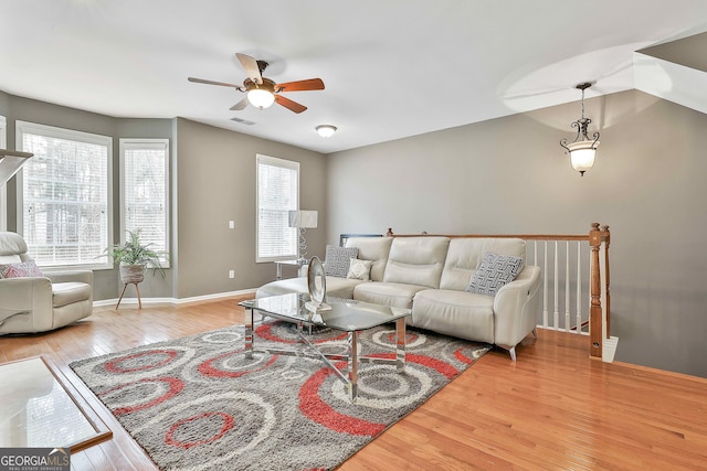 living room with hardwood / wood-style flooring and ceiling fan