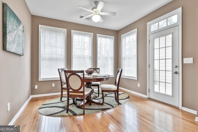 dining room with light hardwood / wood-style floors and ceiling fan