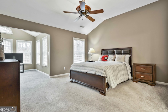 carpeted bedroom with vaulted ceiling and ceiling fan