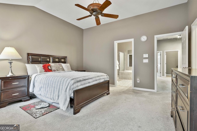 carpeted bedroom with ceiling fan, lofted ceiling, and ensuite bath