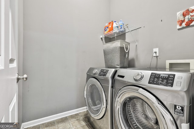 clothes washing area with washing machine and dryer