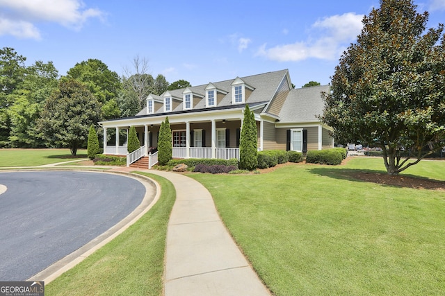 cape cod house featuring a front yard and a porch