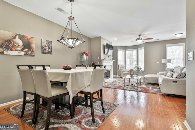 dining area with ceiling fan and light hardwood / wood-style flooring