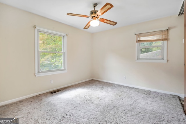 carpeted spare room with ceiling fan