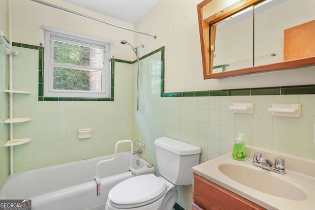 full bathroom featuring tile walls, tiled shower / bath combo, vanity, and toilet