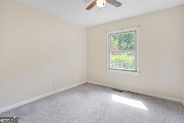 unfurnished room with ceiling fan and carpet flooring