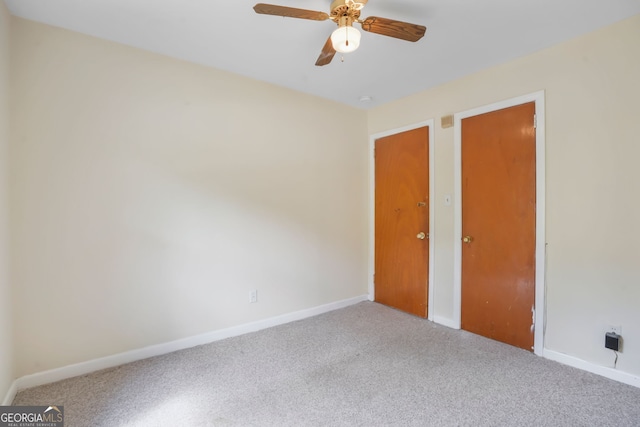 unfurnished bedroom with ceiling fan and light carpet