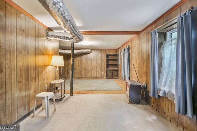 basement featuring wood walls