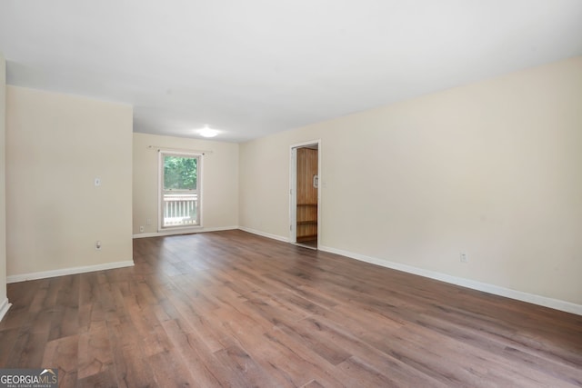 unfurnished room with wood-type flooring