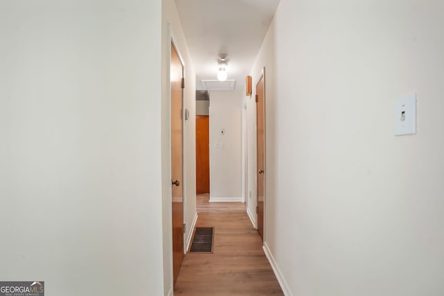 corridor with light hardwood / wood-style flooring