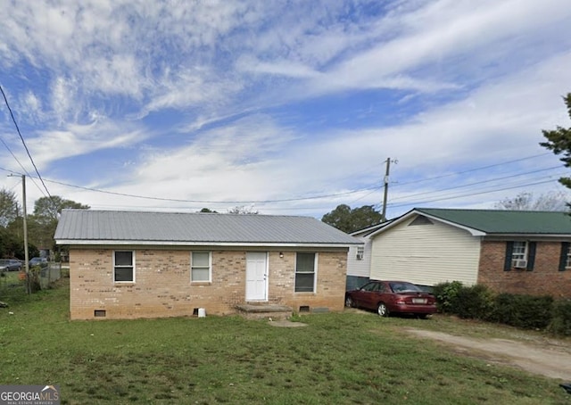 ranch-style home featuring brick siding, dirt driveway, crawl space, metal roof, and a front lawn