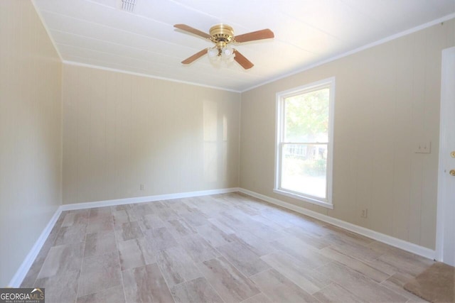 unfurnished room featuring baseboards, a ceiling fan, and crown molding