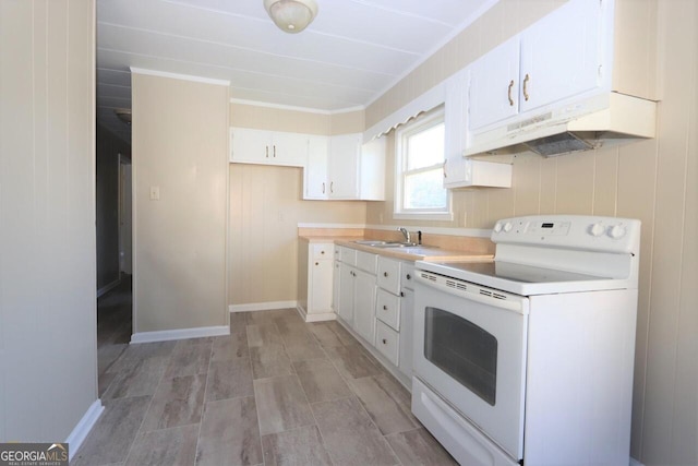 kitchen featuring white cabinets, electric stove, light countertops, under cabinet range hood, and a sink