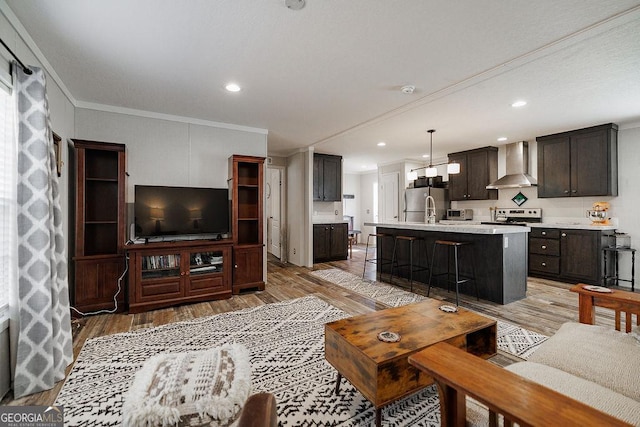 living room with hardwood / wood-style flooring and crown molding