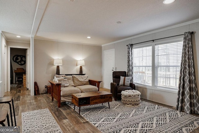 living area with hardwood / wood-style flooring and crown molding