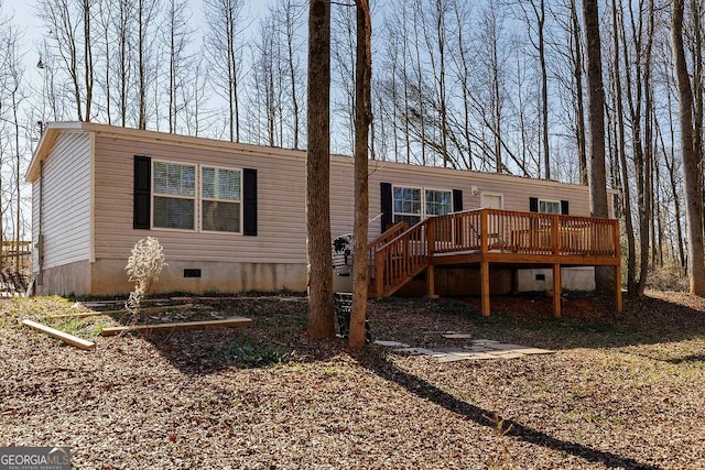 back of house with a wooden deck