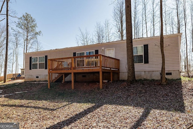 back of property with a wooden deck