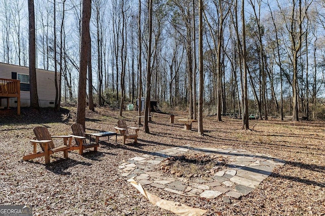 view of yard with a fire pit