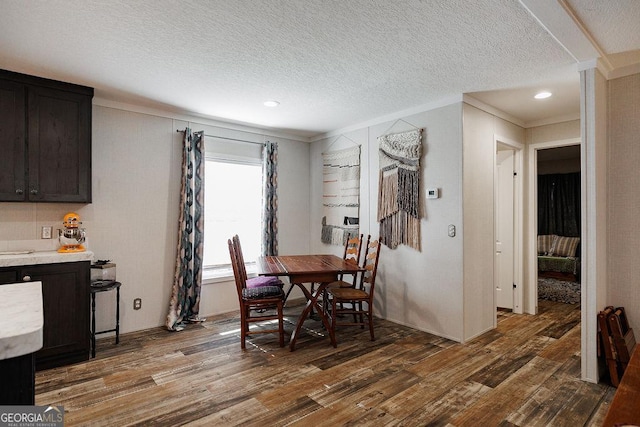 dining room with crown molding, a textured ceiling, and dark hardwood / wood-style flooring