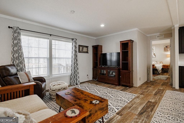 living room with ornamental molding and wood-type flooring