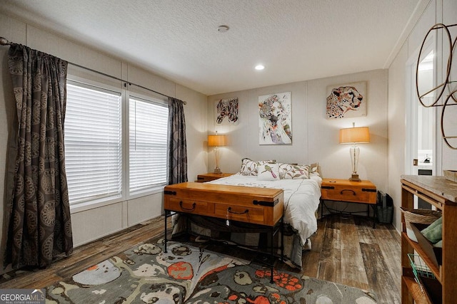 bedroom featuring dark hardwood / wood-style floors and a textured ceiling